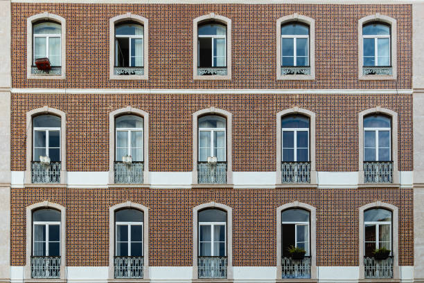 Close-up of classic portuguese tile wall facade and french window balconies in central Lisbon in Portugal