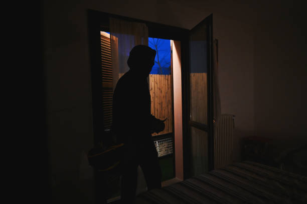 istock masked burglar with crowbar 2196967819