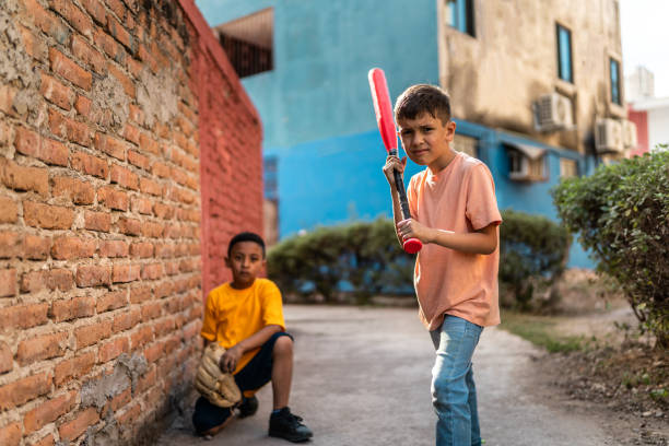 Child boys playing baseball outdoors