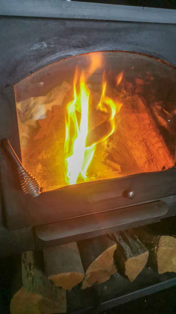 istock flames inside a stove with a glass door 2196968943