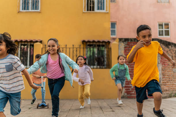 istock Child friends playing running outdoors 2196969028