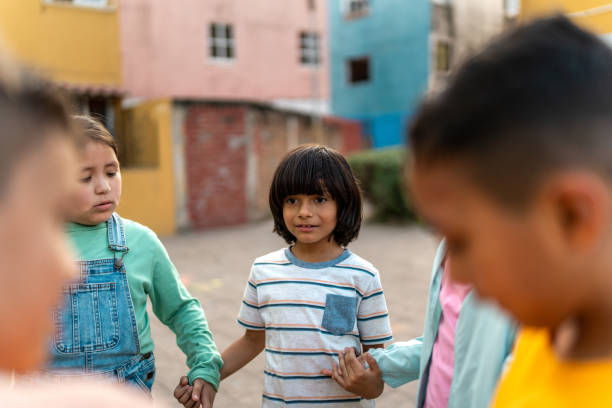 Child friends playing hands game outdoors