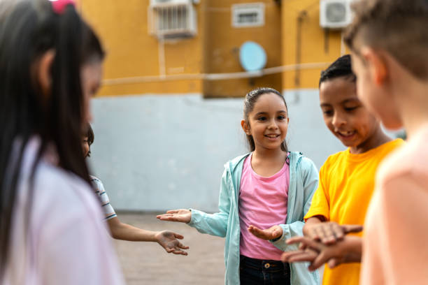 istock Child friends playing hands game outdoors 2196969156