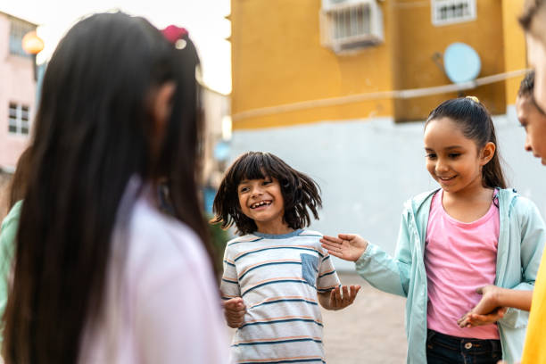 istock Child friends playing hands game outdoors 2196969170