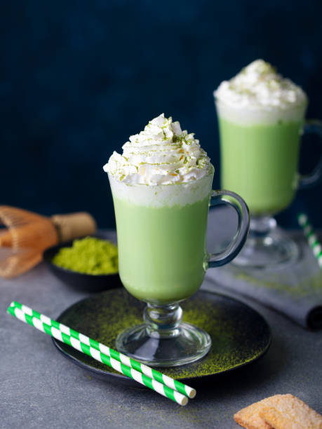 istock Matcha green tea latte with whipped cream. Dark blue background. Close up. 2196969474