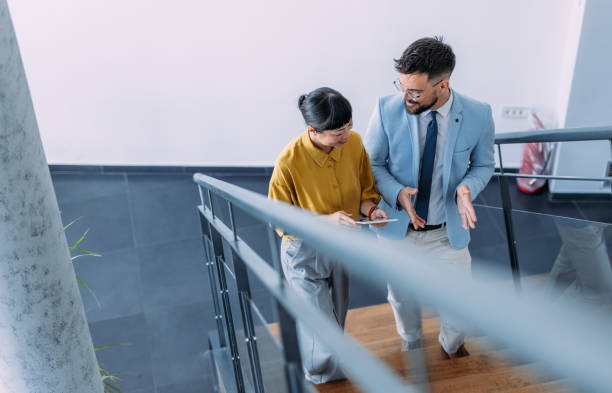 istock Business colleagues talking on stairs in the office. 2196969782