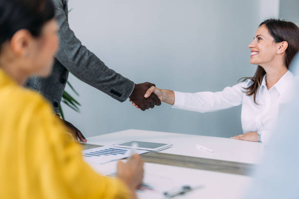 istock Businesspeople shaking hands across the table. 2196969788