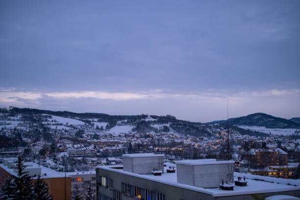 istock Winter Townscape with Twilight Glow and Snow-Covered Hills 2196970479