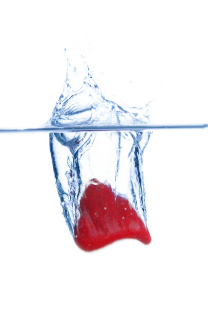 Red heart falls with a splash into  water. Valentines day card