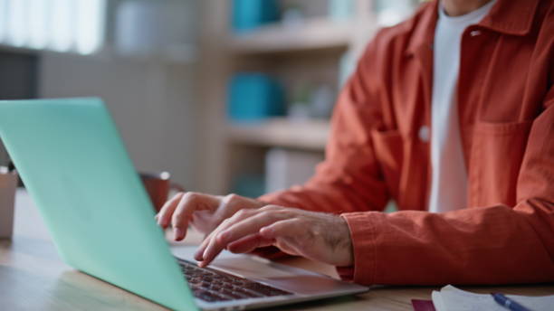 istock Employee hands inputting data in laptop sitting modern company workplace closeup 2196972976