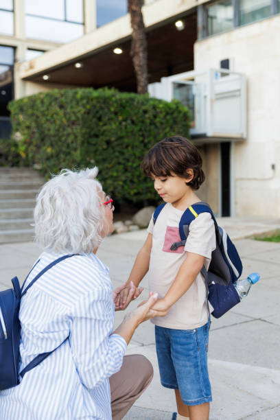 istock Grandmother holding hands with grandson before school 2196974709