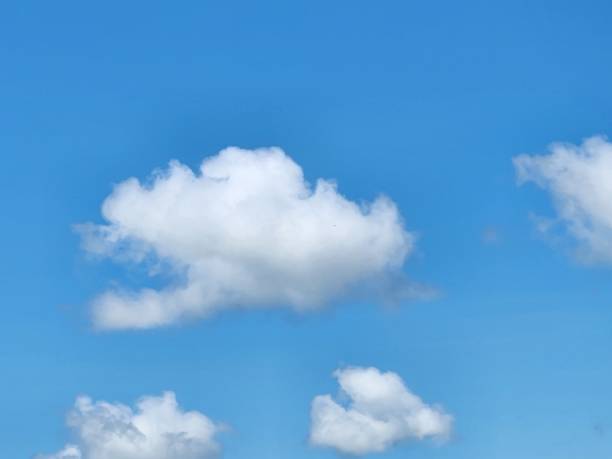 istock The open sky, adorned with white clouds drifting gently, creates a tranquil and serene landscape, where the sunlight blends with soft shadows, bringing a sense of peace. 2196975133