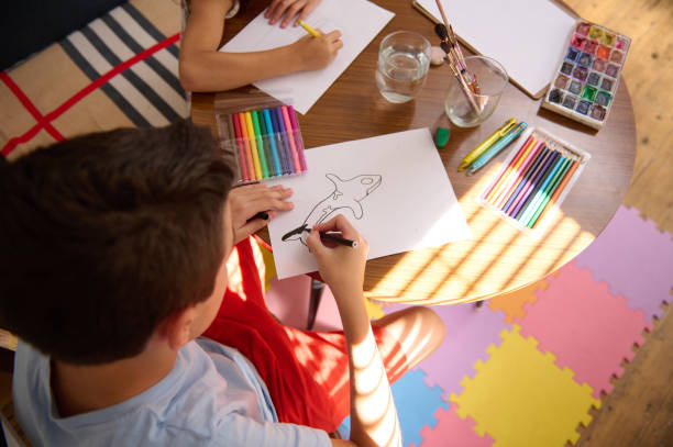 istock Children Coloring and Drawing Together at a Table 2196978091