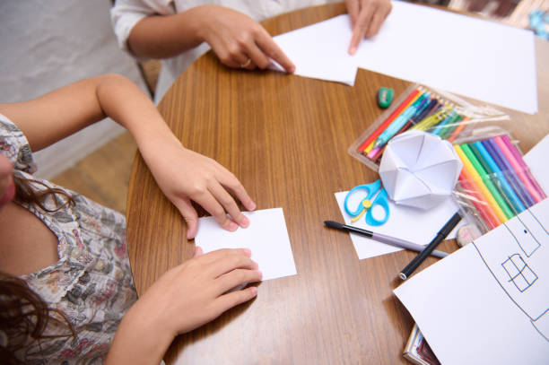 istock Children engaged in creative art activities with colorful tools on a wooden table 2196978137