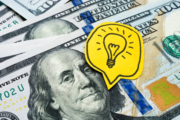 istock Dollars and a light bulb. Business ideas and financial innovation. 2196978869