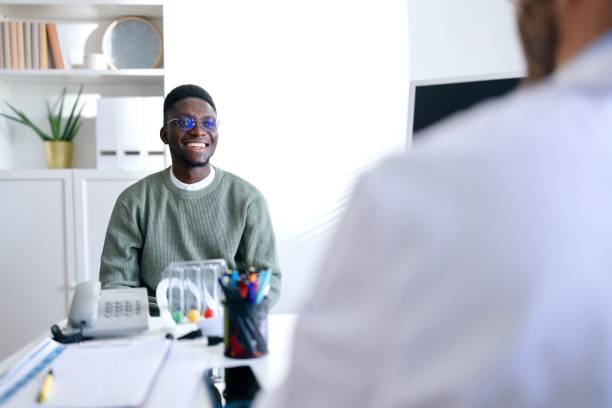 istock Smiling patient talking with his doctor 2196979931