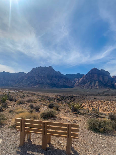 istock Empty bench overlooking a vast desert landscape with mountain views 2196980758