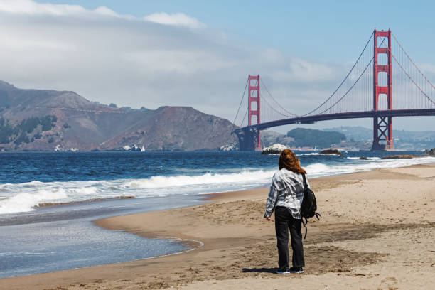 istock A person looks at the Golden Gate Bridge from a sandy beach 2196982593