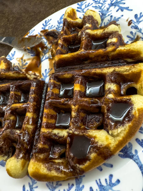 istock Close-Up of Chocolate Syrup Waffles on Decorative Plate 2196982685