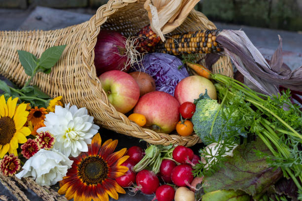 istock Cornucopia overflowing with autumn fruits, vegetables, and flowers 2196983058