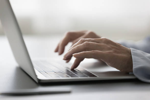 istock Closeup shot female hands typing text on laptop keyboard 2196987789