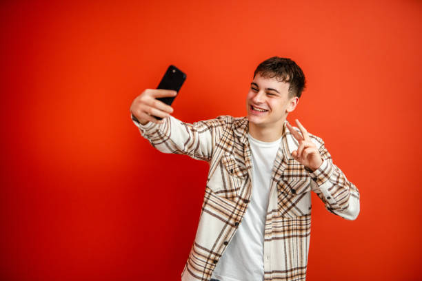 istock young man make have a video call on mobile phone talk studio shot 2196991519