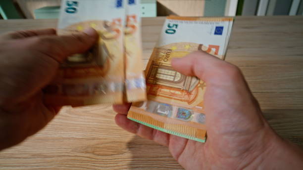 istock Financier hands counting euro banknotes at table closeup. Unknown businessman 2196993285