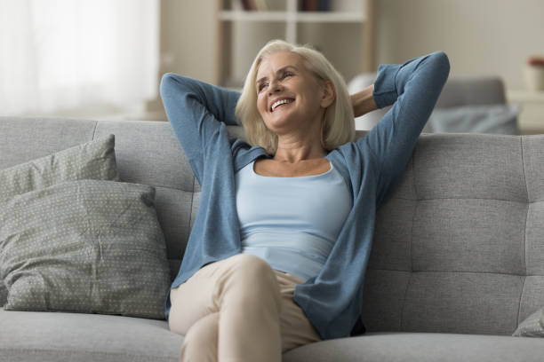 istock Peaceful happy senior woman relaxing on soft sofa 2196993771