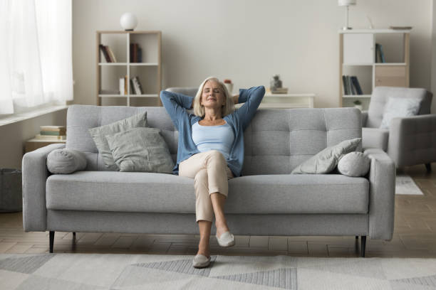 istock Peaceful elderly woman rest on sofa at home 2196994671