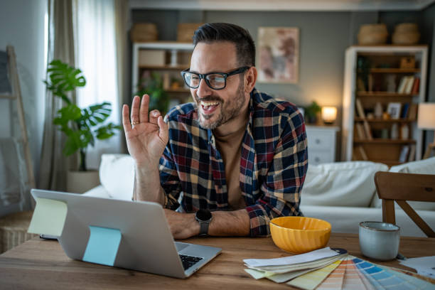 istock Designer on a video call, discussing a project in his home office 2196995360