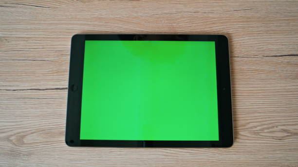 istock Green screen horizontal tablet placed at remote workplace closeup top view. 2196997078