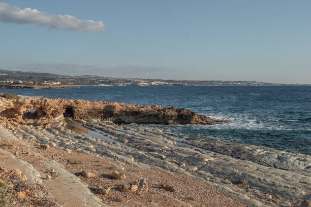Sea caves, cliffs and arches landscape in Cyprus, Paphos. White stones cave cliff rocks Mediterranean sea geologic panorama