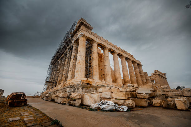 Ancient ruins, columns of the Acropolis in Greece against the background of a gloomy stormy sky with clouds