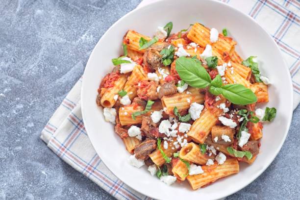 istock Rigatoni alla Norma pasta with eggplant, tomato, basil, ricotta salata, horizontal, top, copy space 2197002654