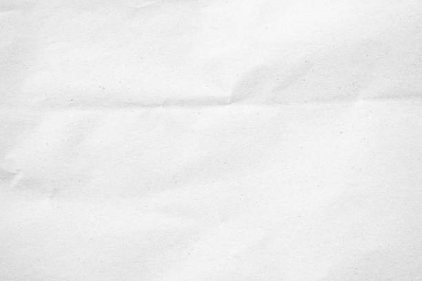 istock White recycled craft paper texture as background. Grey paper texture, Old vintage page or grunge vignette of old newspaper. Pattern rough art creased grunge letter. Hardboard with copy space for text. 2197003239