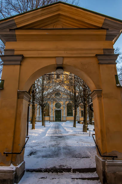 Stockholm, Sweden An arched gate entrance to the Katarina Churchyard and cemetery in the snow.