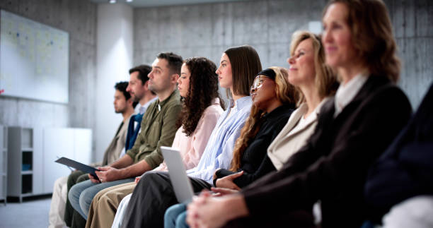 istock Employees waiting for job interviews in diverse office setting 2197012453