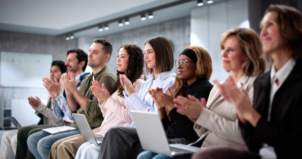 istock Thrilled crowd at business event watching diverse speakers presenting 2197012460