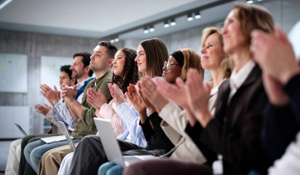 istock Smartly dressed audience of diverse business professionals applauding 2197012466