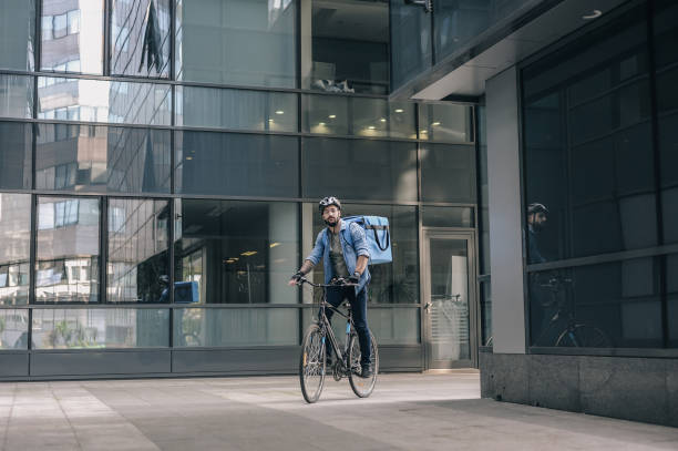 istock Cyclist Delivery Person in Urban Setting Morning 2197013722