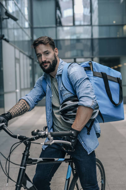 istock Modern Urban Cyclist Courier with Backpack and Bicycle in Early Morning 2197013728