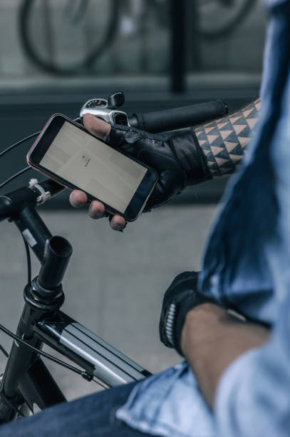 istock Cyclist Checking Smartphone GPS in Early Morning 2197013730