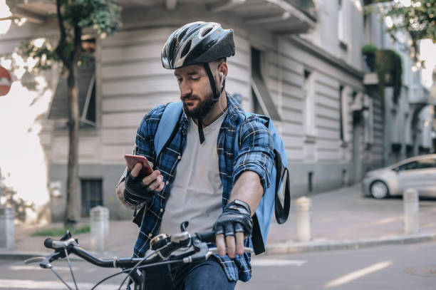 istock Cyclist Checking Phone on City Street During Daytime 2197013734