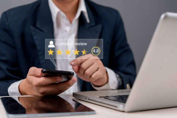istock A businessman using a smartphone to check customer reviews and ratings. Online feedback, reputation management, and digital marketing concept for business growth. 2197017190