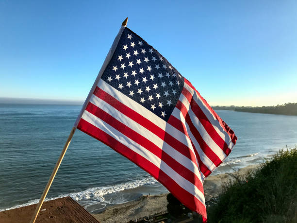 istock American Flag Flying by the Ocean on a Sunny Day 2197021124