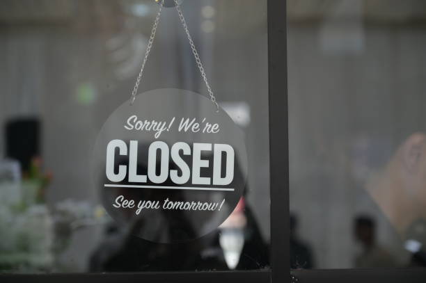 Store closed sign hanging on the window