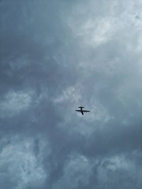 istock Airplane flying in the cloudy sky 2197025295