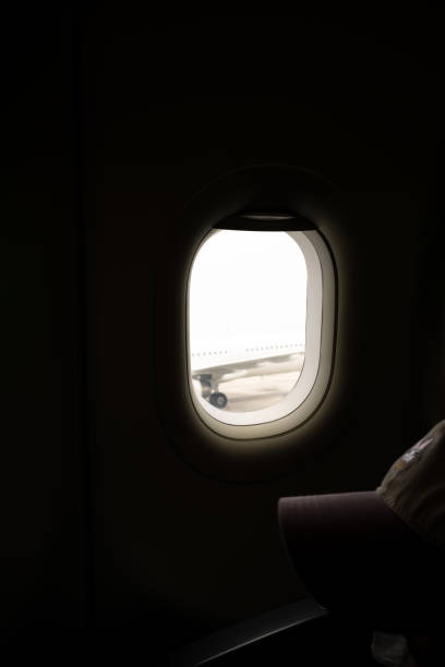 istock Silhouette human face in airplane window 2197027081