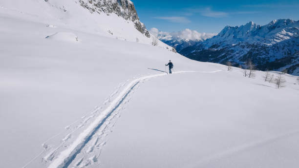 istock Raised view of backcountry splitboarder climbing mountain 2197031715
