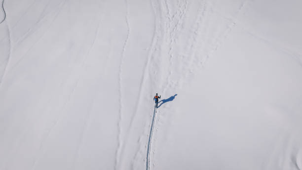 istock Raised view of backcountry splitboarder climbing mountain 2197031792